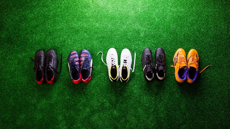 colourful football boots on grass