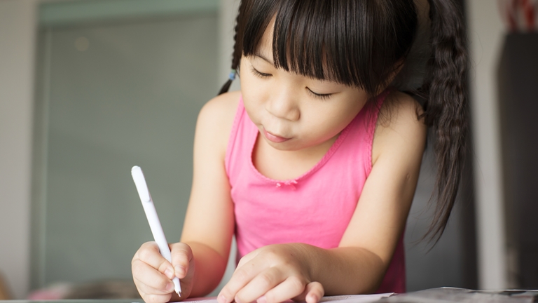 young girl writing