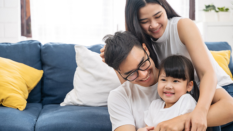 A happy Asian family in the living room