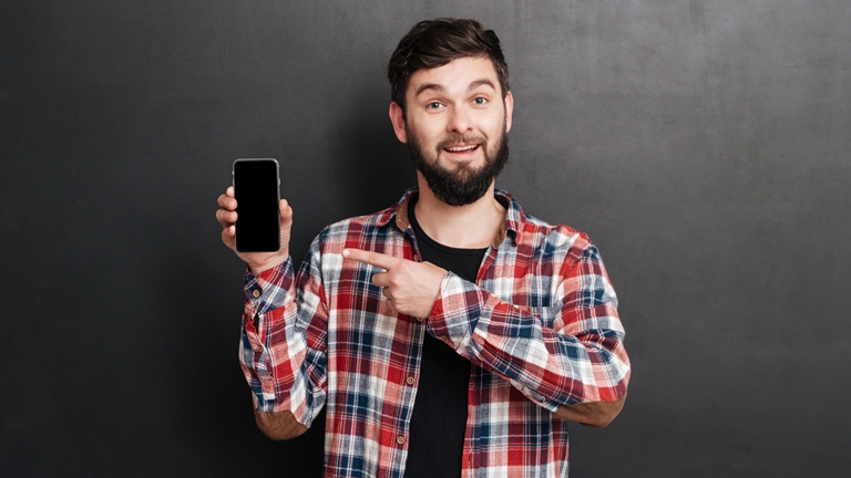 Young man pointing at a smartphone