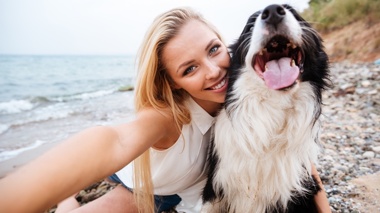 young woman taking selfie with a dog