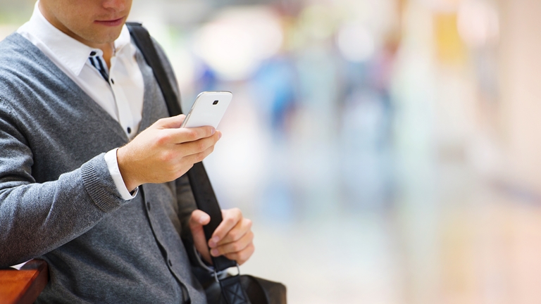 man holding a phone outdoors