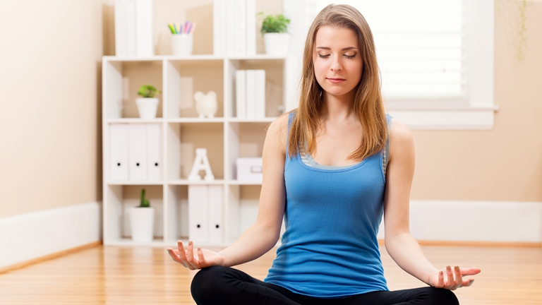 woman meditating at home